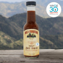 Load image into Gallery viewer, The Whole 30 approved logo with a 5 ounce jar of Bold Mountain Harvest Smokin’ Hot Sauce in front of a mountain view.
